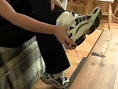 Lexi taking of her sweaty sneakers